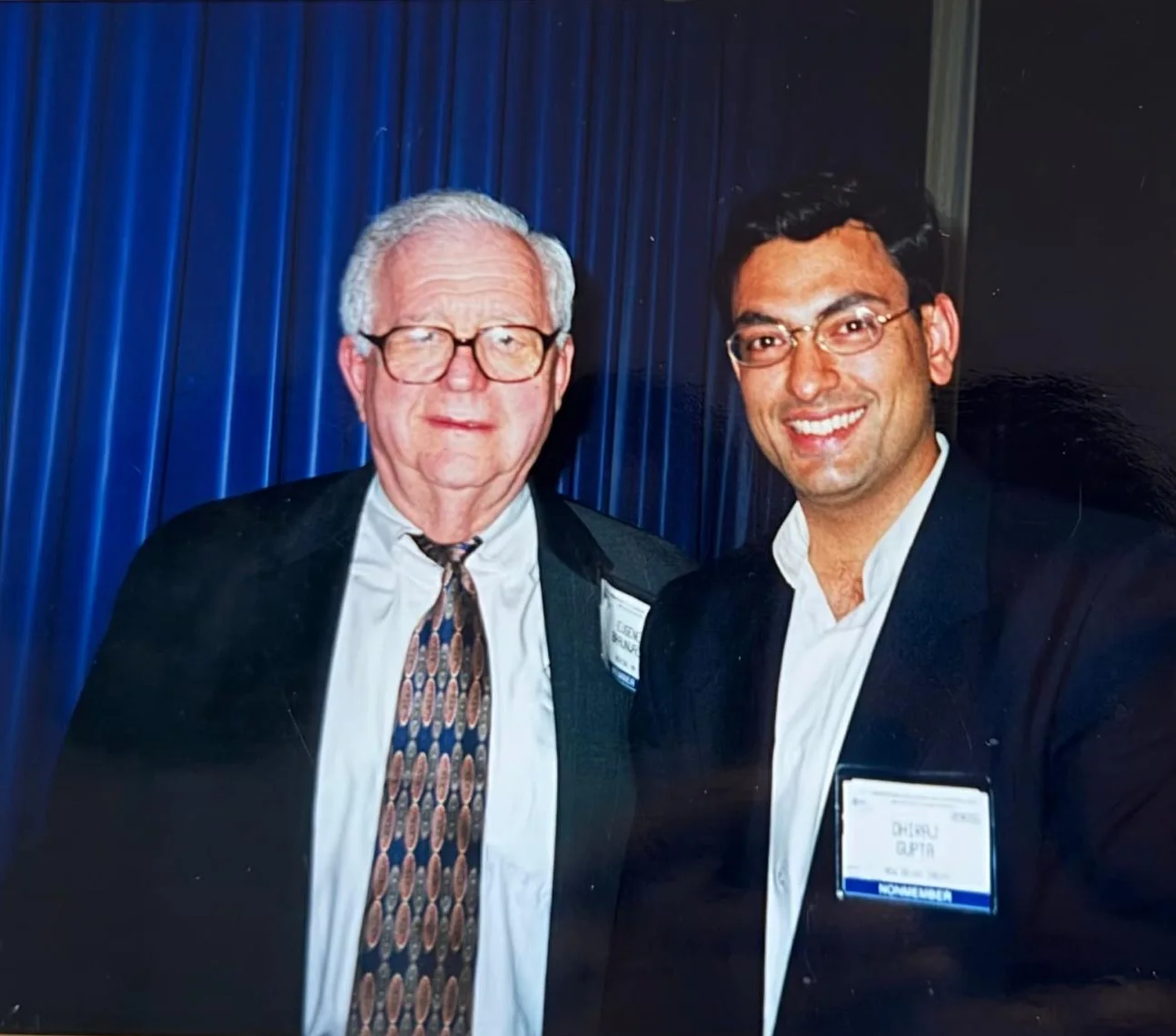 Dr Dhiraj Gupta, wearing a delegate badge reading New Delhi, India, with a senior cardiologist at a scientific meeting in 2000.
