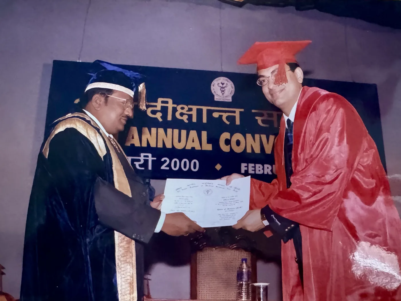 Dhiraj Gupta in scarlet doctoral robes receiving his DM in Cardiology on stage at the AIIMS New Delhi convocation, 2000.