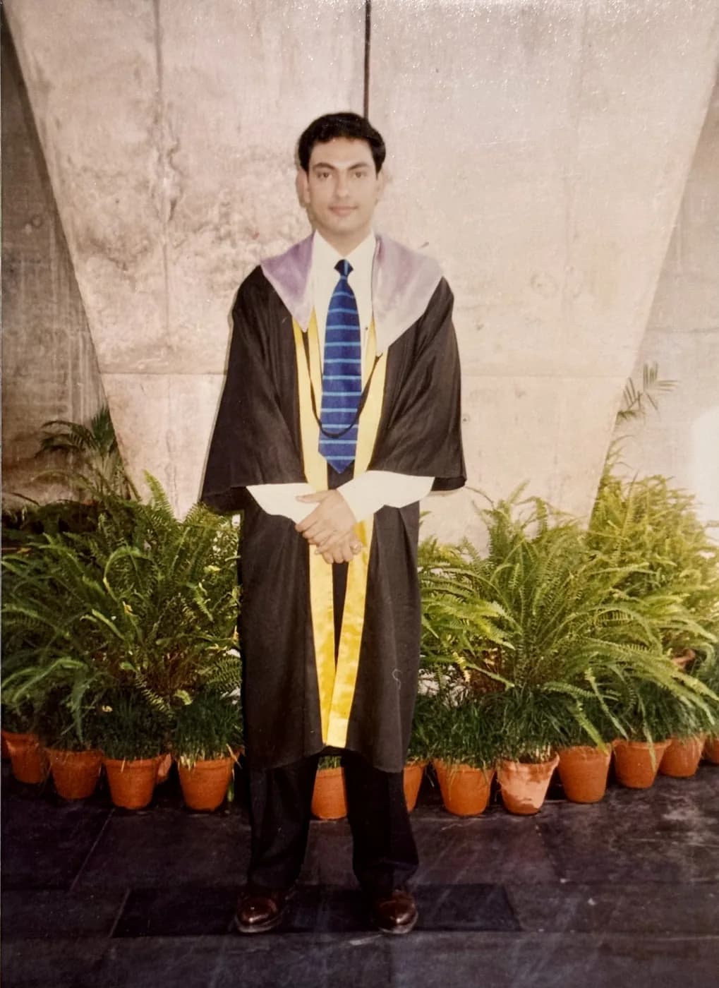Dhiraj Gupta in academic cap and gown at his MB BS convocation in India, 1994.